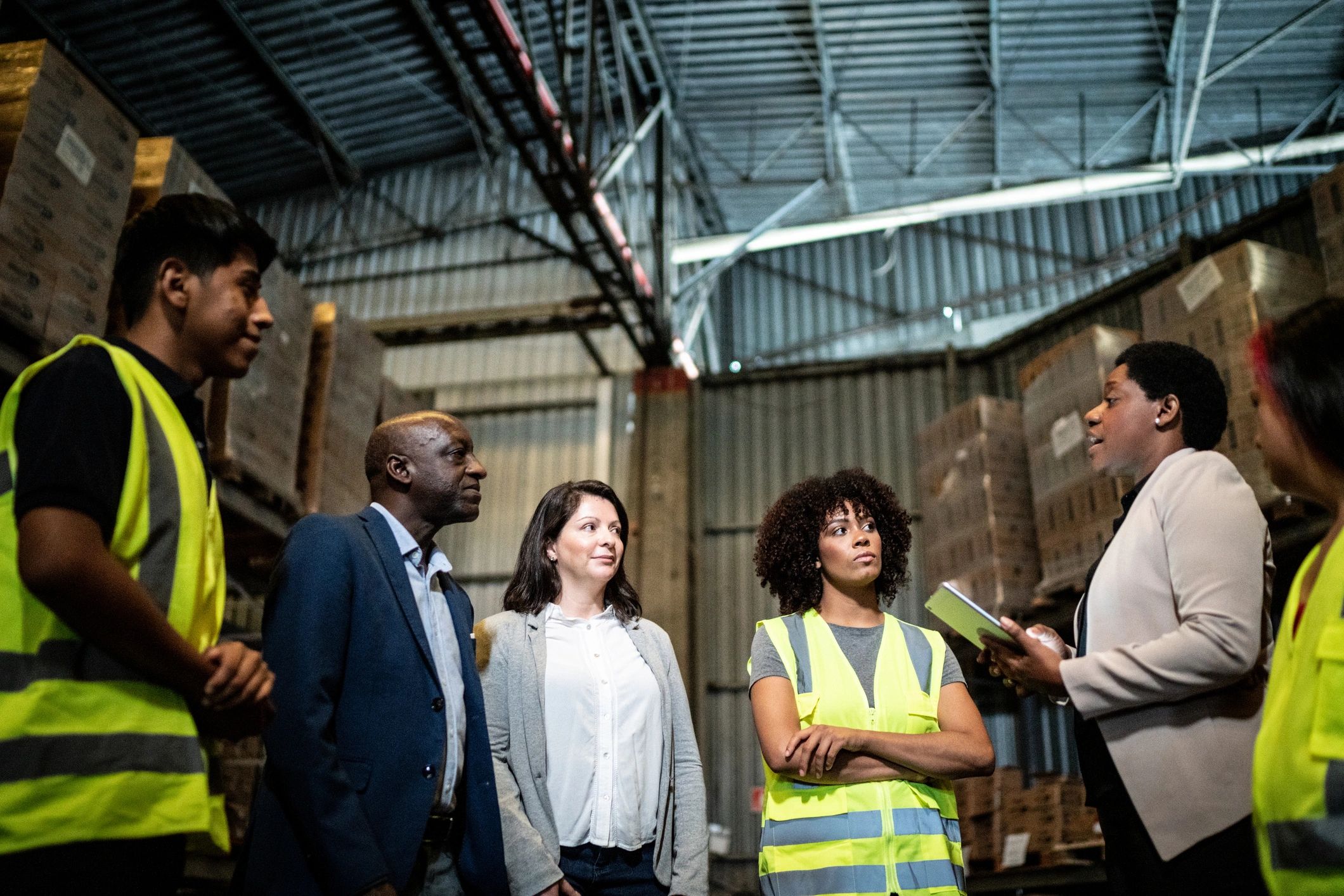 Team meeting in a warehouse environment